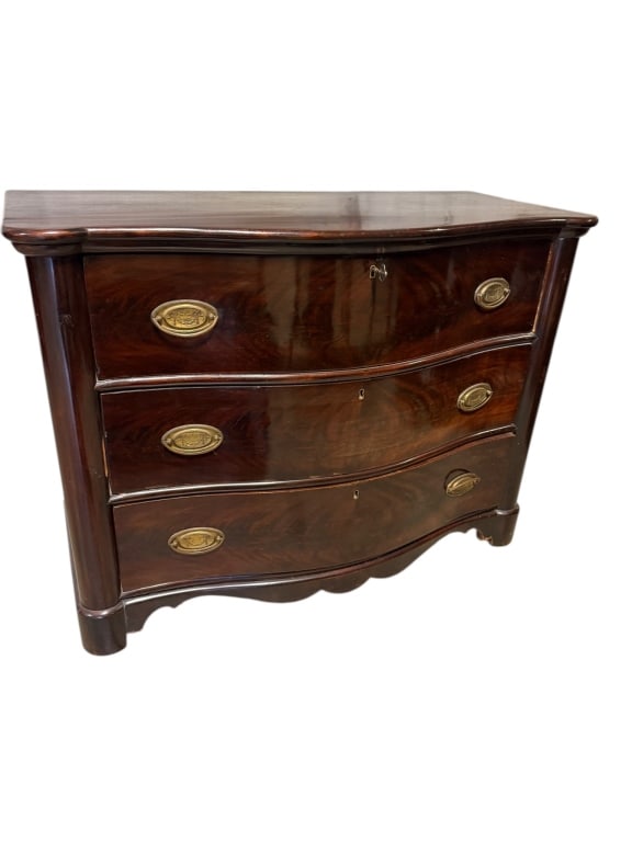 American Bow Front Mahogany Chest: Late 19th C, American bow front mahogany chest featuring a curved front design with three drawers, brass oval pulls, and a replaced back panel. Constructed from dark-polished mahogany with a classic s