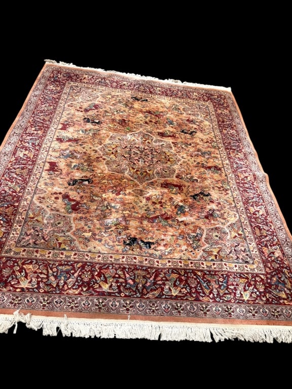 Semi-Antique Karastan Persian Hunting Rug: characterized by its intricate design and rich color palette, primarily featuring shades of red and beige with various detailed motifs. 131 x 104