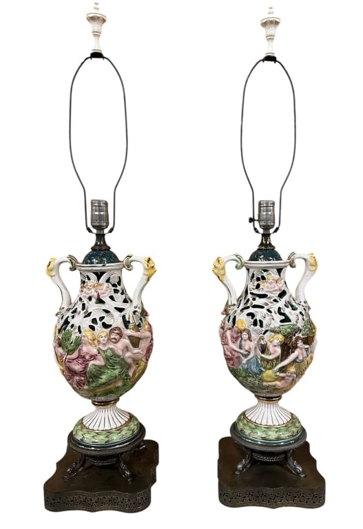 Pair Capodimonte Urn Form Table Lamps: Mid 20th century, reticulated lamps with neoclassical figures, mascaron handles, gilt accents, brass bases and matching resin finials, both work..surface dust and grime, light crazing, wear to bases..