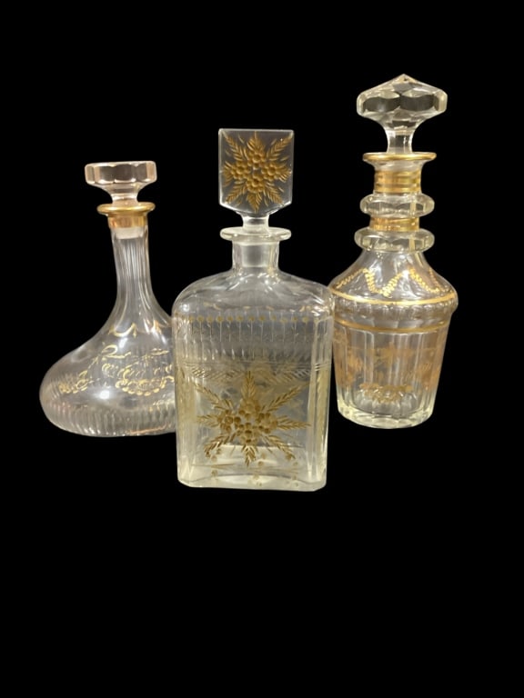 Bohemian Glass Sprits Decanters: 10 inch Ships Captain decanter with flat base, 11.5 inch with panel cut stopper, 10 inch flat sided rectangle style, all with gilt decoration. Line Item # 53