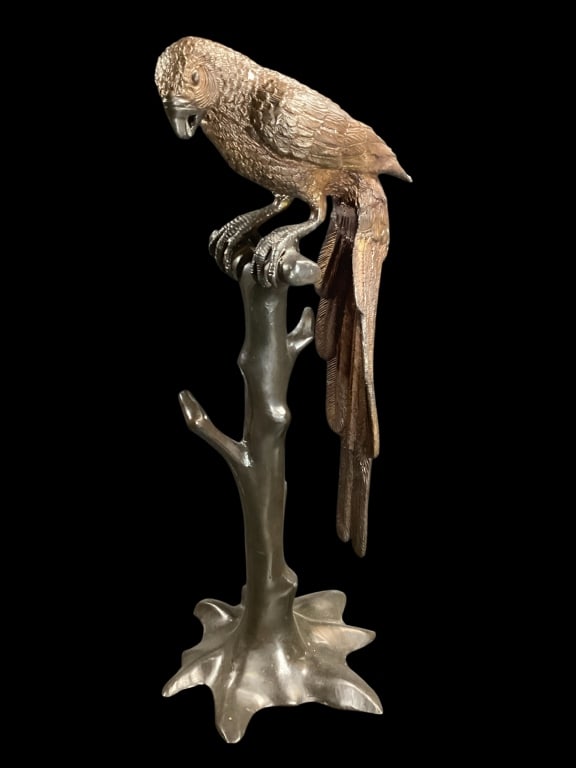 Sculpture of A Macaw: Contemporary 23 inch tall bronze finished sculpture. In style of Brad Keeler, with detailed feather work, open beak. He sits atop oa tree branch stand