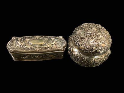 Sterling Vanity Boxes: Kirk and Son Repousse lidded box, 4 inch diameter adorned with multi florals, marked to base. Gorham 5 inches tall oblong hinged box. Puti with urns of fruit and floral swags. Nice pieces, 11.13 ozt t