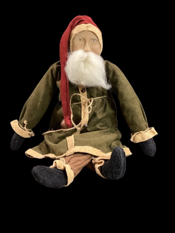 Hand Crafted Arnette Santa: Arnettes country store known for their handmade Christmas items. This Santa has stuffed body, dressed in felt robe/ coat with twin belt, long stocking cap with bell tassel, painted clay face.