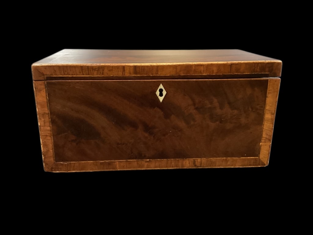 English Regency Tea Caddy: Mahogany case with string inlay, bone escutcheon, interior with two side compartments, center fitted section would have held mixing glass. 11.5 x 6 x 6 inches. * no key, no mixing glass, light scuff t