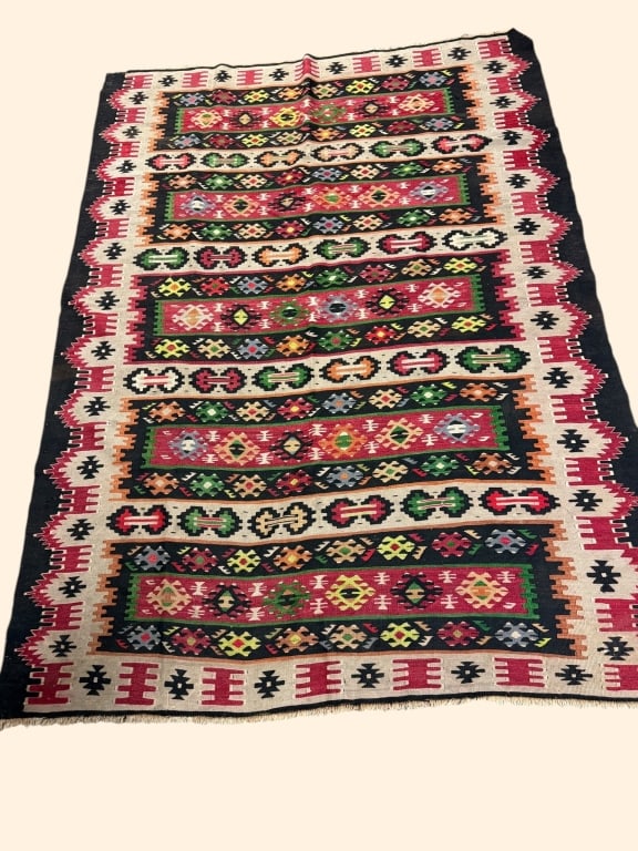 Colorful Vintage Handwoven Kilim Rug: Vibrant handwoven wool Kilim rug featuring alternating horizontal bands of geometric tribal motifs in shades of red, green, gold, blue, and black. Traditional flatweave construction with intricate dia
