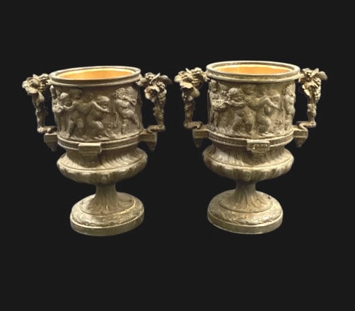 Pair Decorative Bronze Finished Urns: Neoclassical styled bronze finish, metal urns, 9 x 5 inches, decorated with with Bacchus figures, celebrating the Roman god of wine. Grape vine handles, Line Item # 18