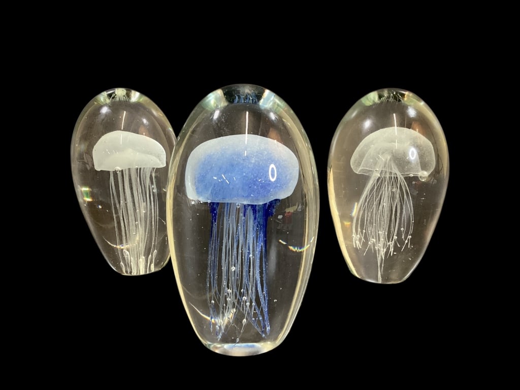 Three Art Glass Paperweights: In style of Murano , three Jellyfish Paperweights. 7 inches tall diameter tall orbs, with trailing tentacles. One in blue, two others with opaque tint