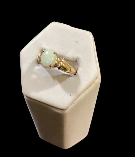 14 K Gold and Opal Ring: Ladies 14 k yellow gold opal center stone with diamond surrounding. Size 8