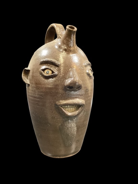 Billy Henson Face Jug: Southern Folk Pottery face jug, 15 inches tall, with seal ears, nose, open mouth with teeth. Goatee, and bushy brows. Artist Billy Henson, Lyman SC signed and dated 1996