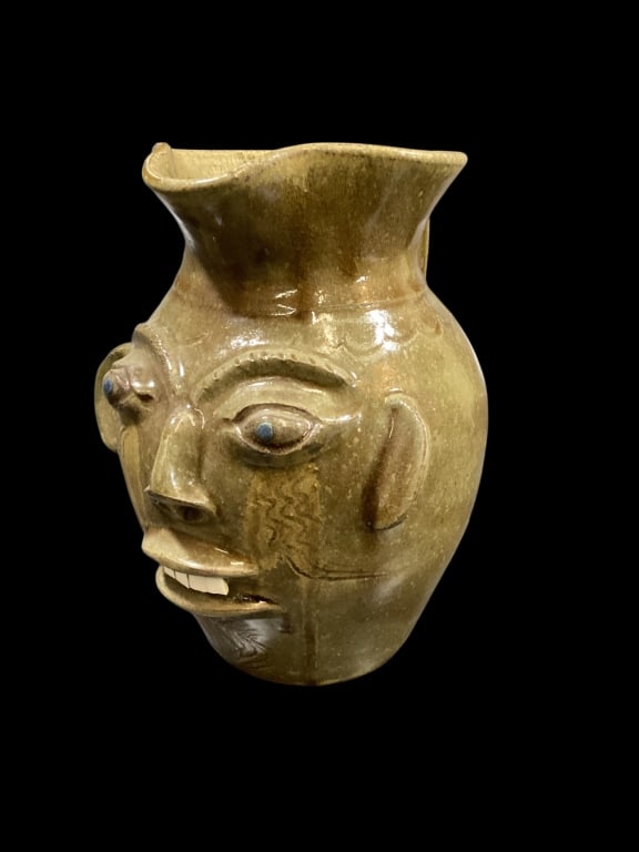 Walter Fleming Face Pitcher: Southern Folk Pottery Ugly Face Jug.. alkaline glazed with1 row China chip teeth. Bug blue eyes, drip runs at handle, signed base.