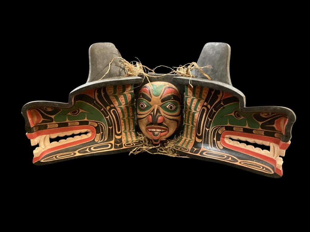 Northwest Coastal Transformation Mask: Hand Carved Kwakwaka wakw Indigenous Tribal mask. Worn by dancers during ceremonies. Carved from cedar wood and brightly painted. The mask opens to reveal 25 x 14 inches, an inner face mask.