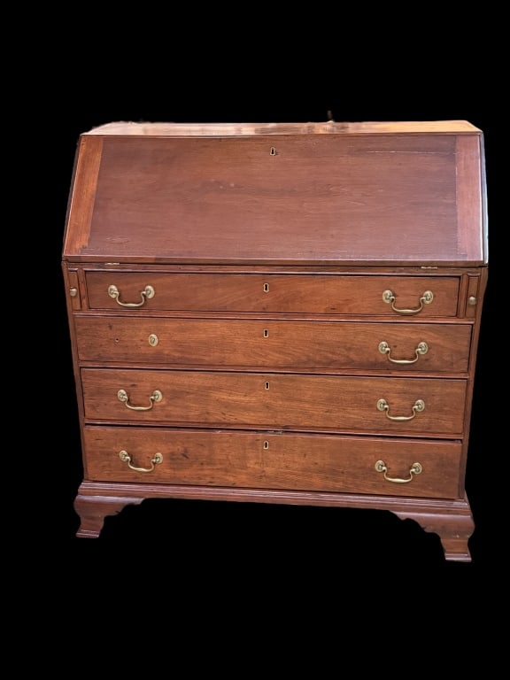 Antique Chippendale Mahogany Slant Front Desk: Fine antique slant-lid secretary desk in rich mahogany, featuring four graduated drawers with brass bail pulls, bracket feet, and an interior fitted with drawers, pigeonholes, and fan-carved prospect