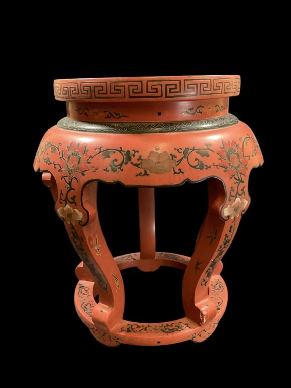 Chinese Red Lacquered Stool: Early 20 th century, featuring a red lacquer finish with hand painted floral motifs, and traditional decoration. Curved open frame, typical Asian aesthetics. 20 x 18 inches