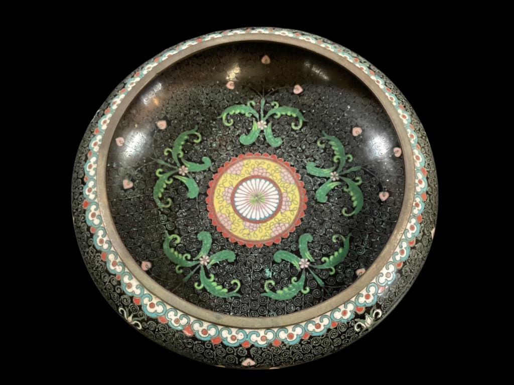 Chinese Cloisonne Shallow Bowl: Overall decorated with florals on a black ground, interior and exterior designs. 10 inch diameter with teal snail tails, clouds.