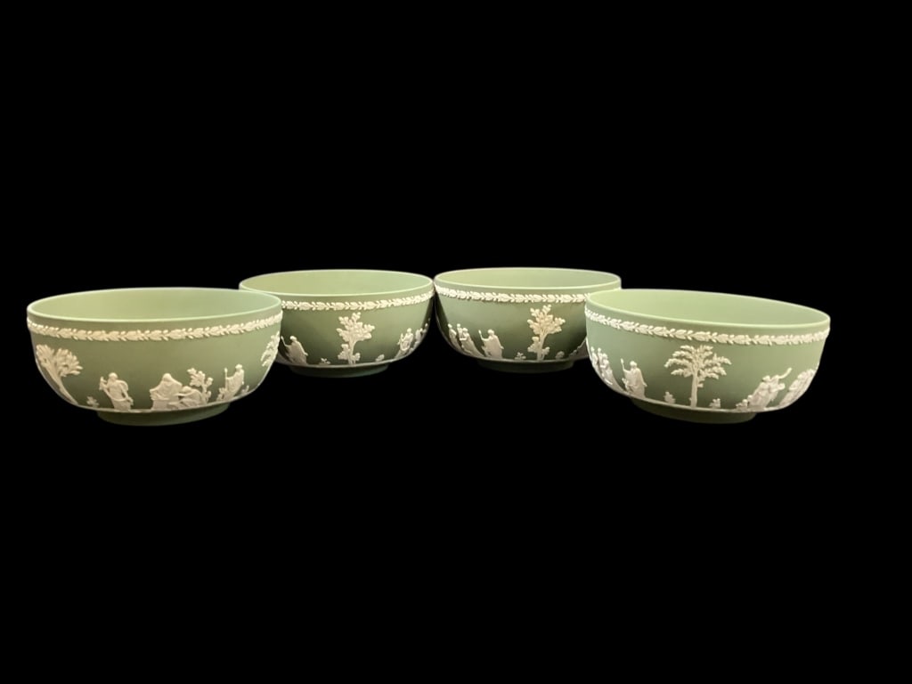 Wedgwood Jasperware Bowls: Four Sage green and ivory bowls, Relief scenes from Greek mythology, 8 inch diameter size, label leaf garlands to rim.