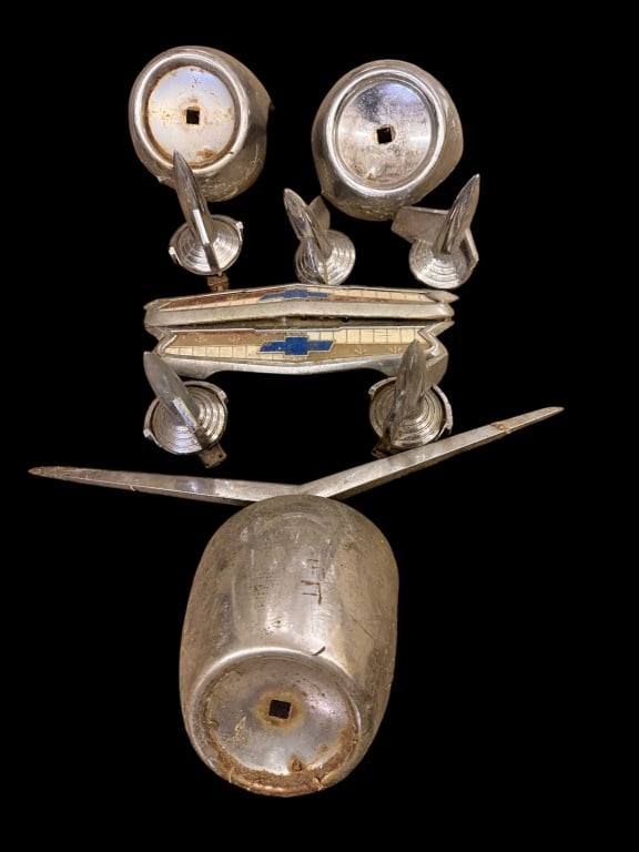 Group of Vintage 1946?1948 Chevrolet Parts: Assorted lot of original mid-century Chevrolet automobile parts, including multiple chrome hood ornaments, headlight buckets, and Chevrolet bowtie trim pieces. Believed to be from 1946?1948 Chevrolet