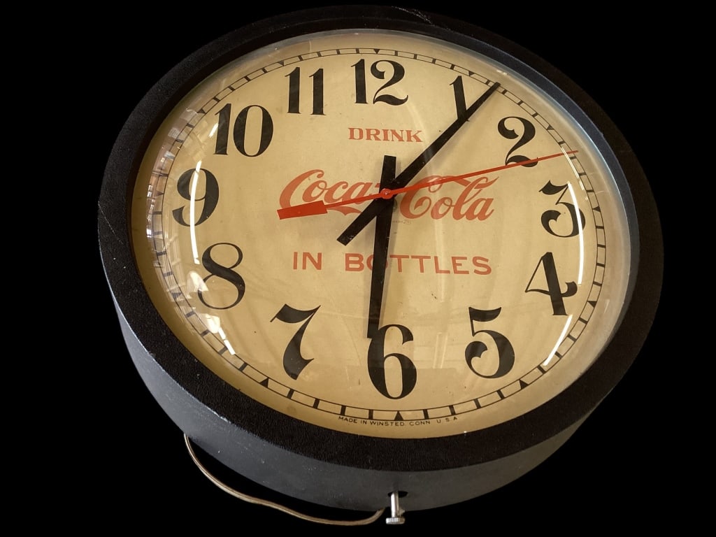 Vintage Drink Coca Cola in Bottles wall Clock: Classic Design with Iconic Drink Coca Cola slogan in Red Script. 13 inch glass bubble face , composite frame in black. Electric