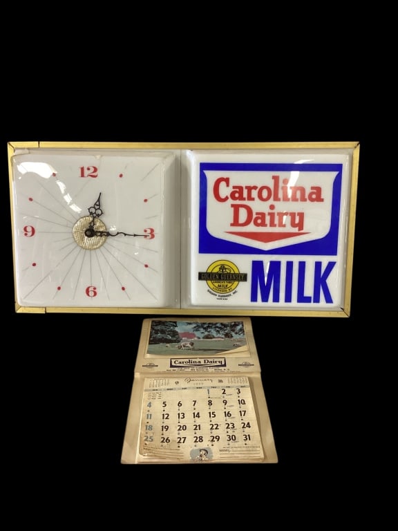 Carolina Dairy Advertising Clock, Calendar: Vintage Carolina Dairy light up advertising clock/sign, 25 x 12 inches, featuring the Golden Guernsey emblem( damaged corner). And a 1959 Carolina Dairy paper wall calendar. All months intact.