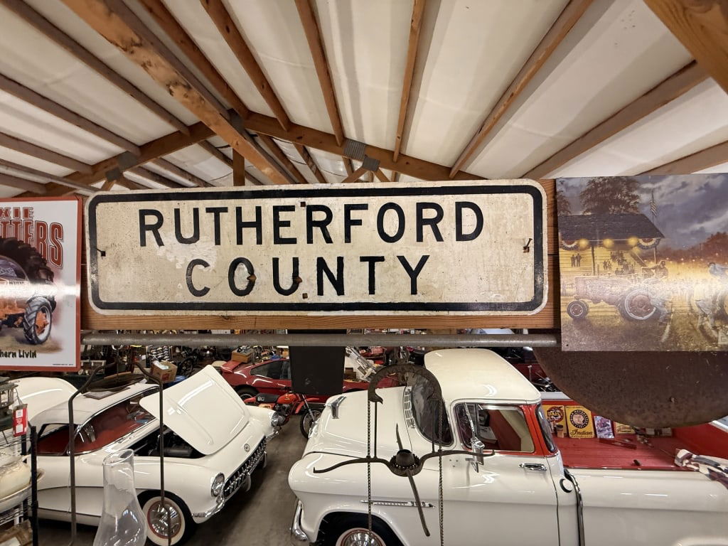 5 pc Assorted Advertising: Rutherford county, John Deere tag, tractor pull, Dixie outfitters Rutherford County Sign is 36 x 10