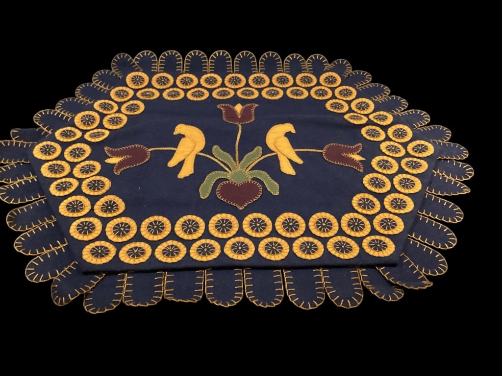 Felted Needlecraft Rug: Primitive Folk Art Style, This contemporary made penny rug featuring alive Birds, and borders Penny rounds. Deep purple to blue felted ground, Mustard yellow and green accent colors, signed by