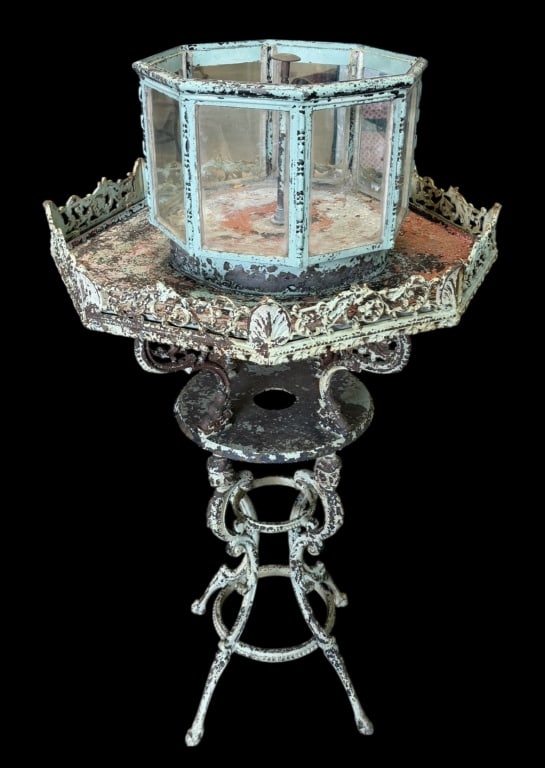 Victorian Aquarium with Fountain: Octagonal aquarium with fountain, cast iron stand with planter tray, dolphin and figural supports..paint loss and rust present, working condition unknown..50H x 29W x 29D inches