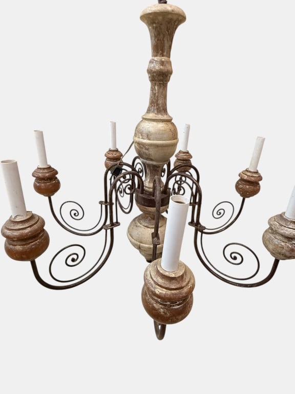 Vintage Farmhouse Chandler: arm chandelier features a hand-carved wooden central spindle and matching base cups finished with a heavily distressed, whitewashed patina that evokes a rustic farmhouse aesthetic. The fixture is