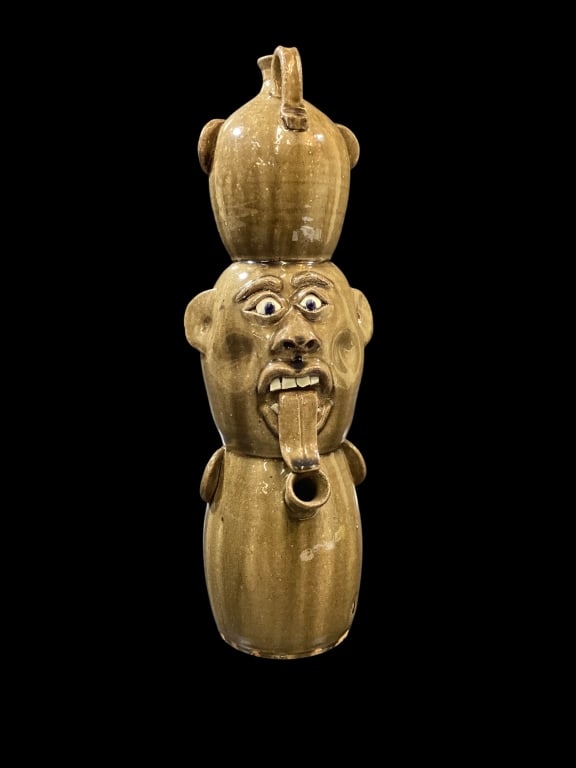 Southern Folk Art Face Jug: Triple stack of jugs, in rich glossy alkaline glaze, thr upper jug showing a dropped open mouth with double rows chip teeth. Blue eyes and busy brows, middle jug in reverse with long tongue, chip teet