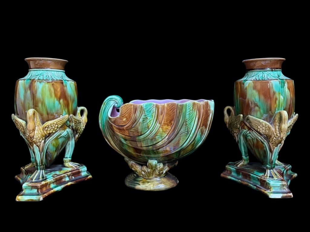 Pair Majolica Vases and Nautilus Bowl: Pair 12 inch vases on stepped triangular base, cranes with outstretched wings supporting each vase, cattail decoration, unmarked; 8.5 inch tall footed nautilus bowl, resting on coral,