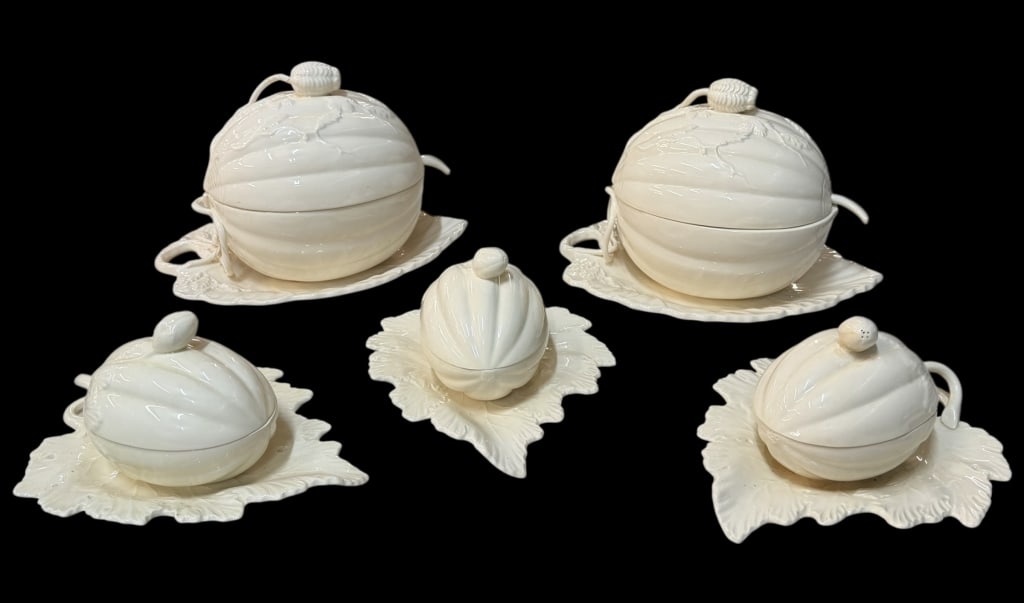 Creamware Porcelain Tureens: Two pumpkin shaped tureens with attached leaf shaped underplates, by Royal Creamware..Three individual pumpkin covered soup tureens, with attached leaf shaped leaf under trays, by