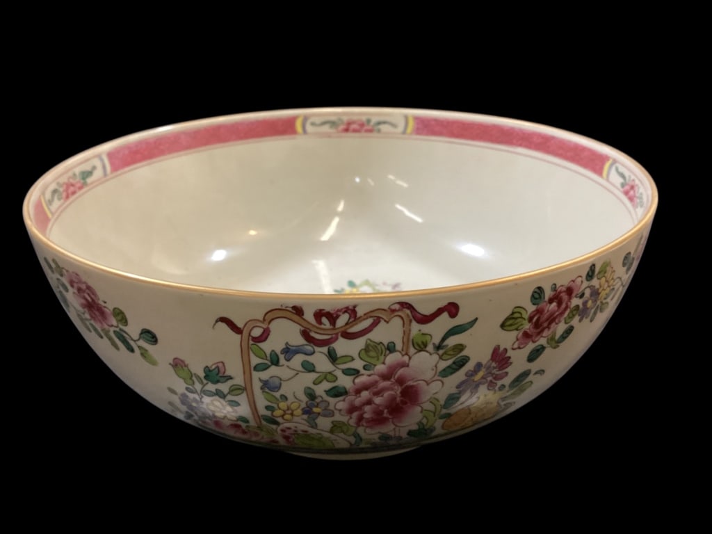 Chinese Famille Rose Porcelain Bowl: Lovely large porcelain punch bowl. 10 inch diameter with a banded pink floral rim, center bouquet with bird, pedestal foot rim, gilt rim.