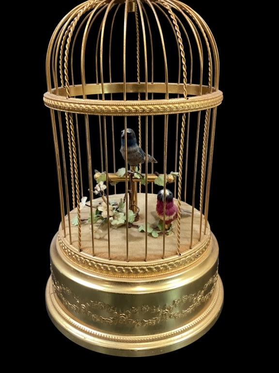 Vintage Swiss Reuge Singing Bird: Vintage Reuge Switzerland Singing Bird in Cage, often referenced as an Automaton. Crafted late 40?s to 60?s , the cage in gilt paint contains 2 small feathered birds who both sing and move their