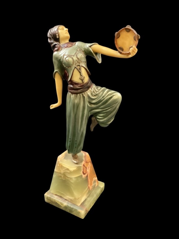 Art Deco Sculpture Oriental Dancer: After Demetrec Chiparus Vintage 12 inch sculpture depicting a female dancer in exotic costume holding a tambourine. Bone and resin features. Mounted to a green marble stepped base.