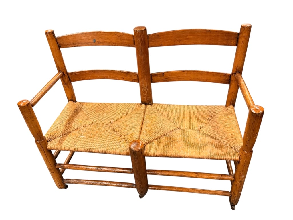Antique Maple Buggy Seat Bench W Rush Seat: Antique maple buggy seat bench featuring a double ladderback form with turned posts and a handwoven rush seat in a diamond pattern. Mounted on a stretcher base with small front casters 28 tall to