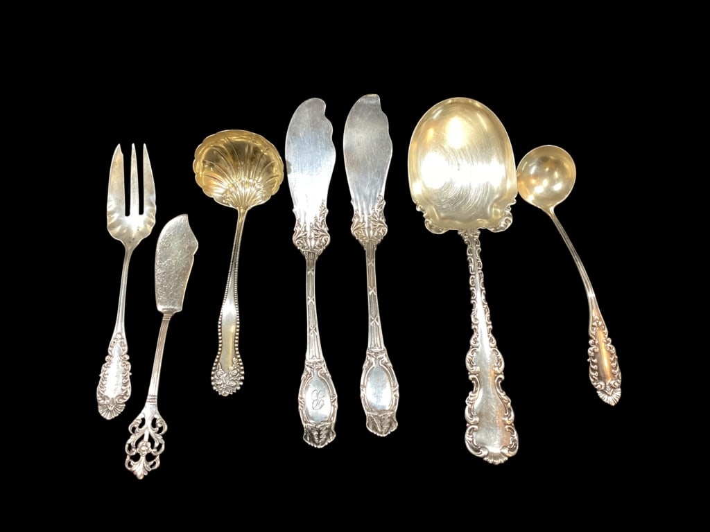 Sterling Silver Serving Utensils: Seven pieces, 8 inch stuffing spoon, 5,5 inch small ladle, two 7 inch butter knives, Gorham 6.5 inch ladle with shell form bowl, 6 inch pastry fork, 5 inch butter knife, Norway. 6.13 ozt