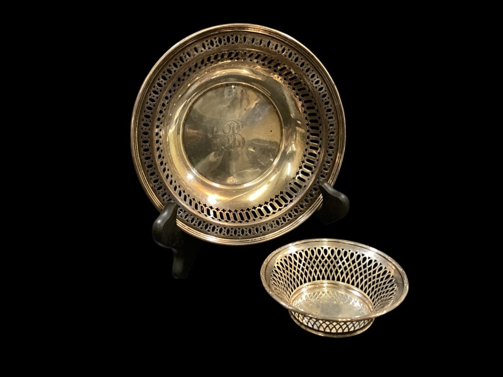 Two Sterling Silver Table Bowls: 7 inch diameter bowl, wide pierced rim and border, center monogram, Gorham 4 inch bowl, lattice worked body, reeded rim 5.72 ozt approximately.