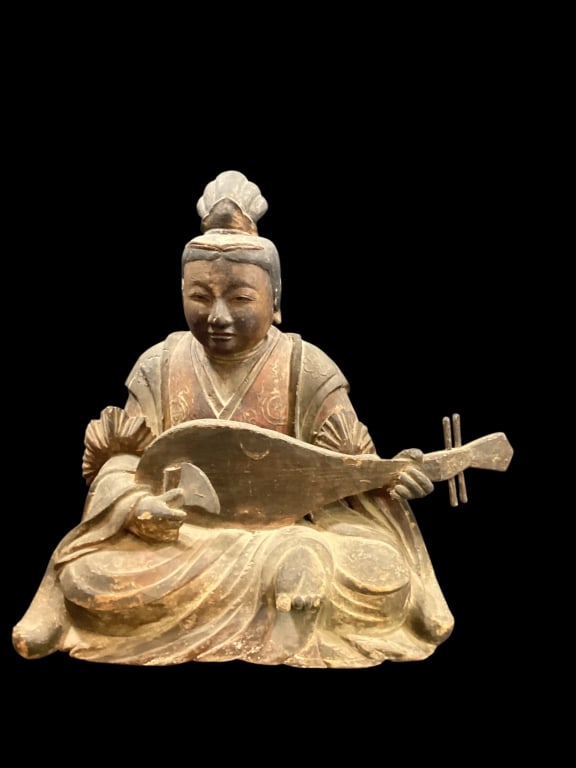 Japanese Seated Musician: Larger size wood carved figure playing a biwa. The figure is 18 x 16, wears traditional robes, with carved topknot, similar to styles found in Shinzo carvings. Trace polychrome paint. * age wear,