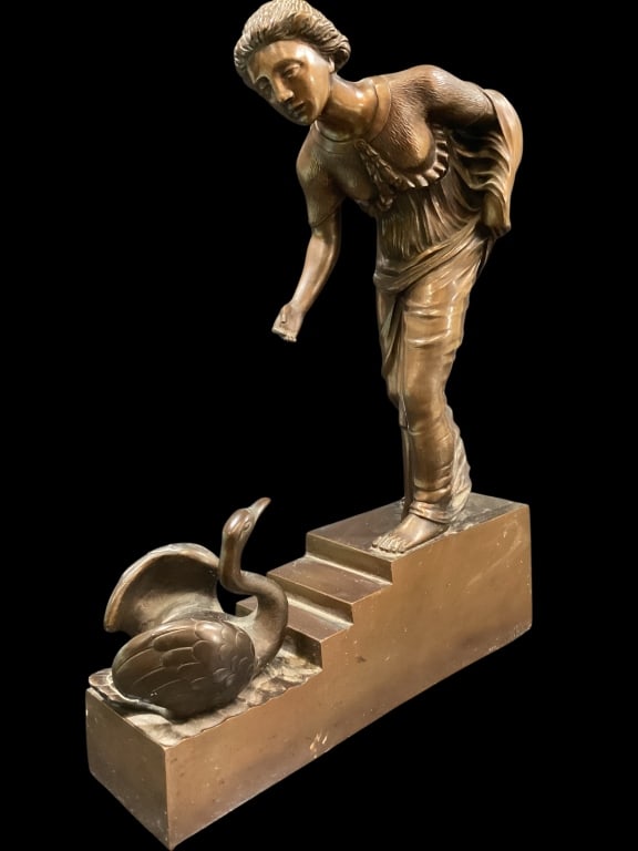 Bronze Sculpture Leda and the Swan: Lovely bronze sculpture of Female reaching down to a resting swan. 14 inches tall x 10.5 length, signed at the base Deibele. Very heavy - ()