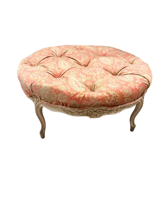 French Provincial Style Tufted Round Ottoman: A charming French Provincial style round ottoman featuring a plush, diamond-tufted top cushion wrapped in a coral and sage green paisley patterned fabric. The exposed wooden base is finished in a
