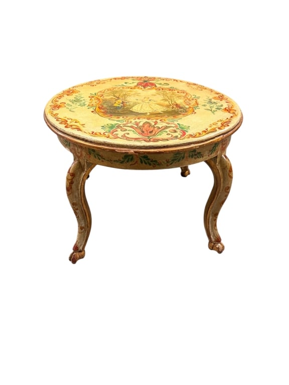 Venetian Style Hand-Painted Round Accent Table: A charming Venetian style round coffee or accent table boasting a vibrant, hand-painted cream lacquered finish. The circular top is beautifully centered with a romanticized pastoral courtyard scene