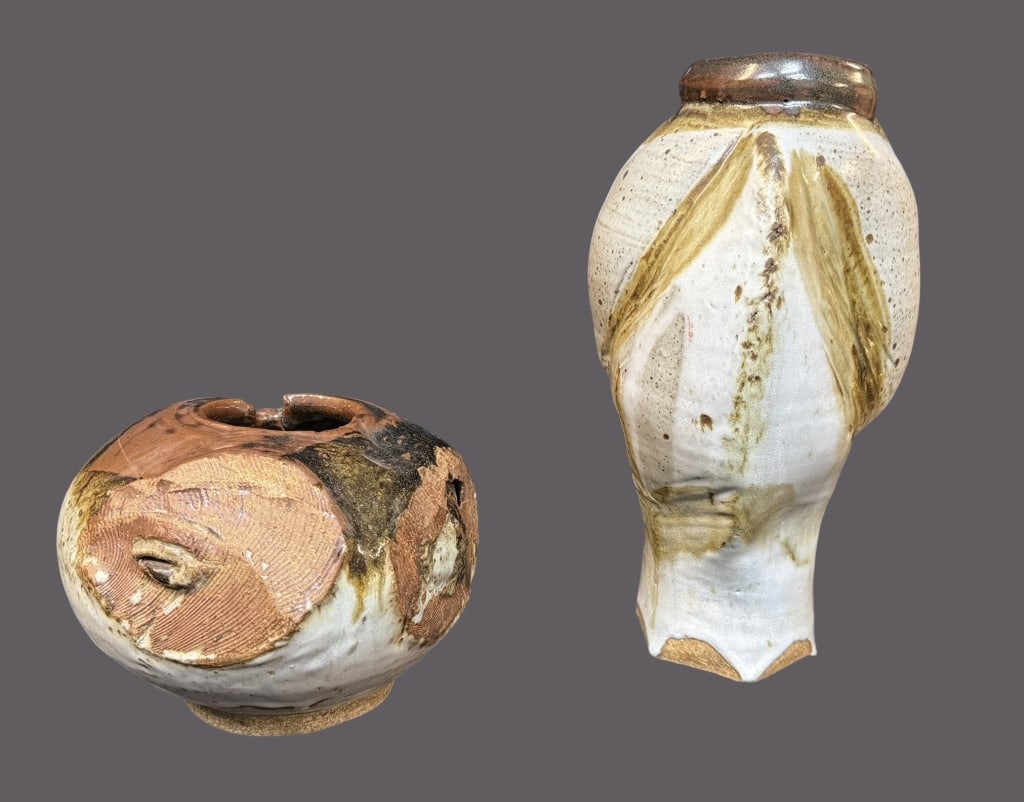 Two Pieces Abstract Art Pottery: 20th century, both signed Shigeko, including: 11.5 inch vase with sculpted form resembling a head, 5.5 inch squat vessel with molded shapes..surface dust, smaller vessel with cracks throughout Line