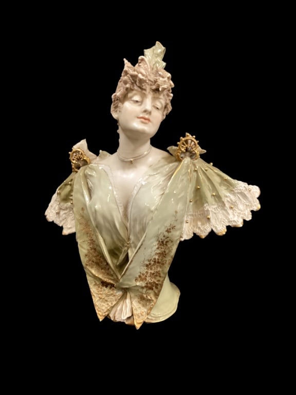 Art Nouveau Porcelain Bust: Glazed gilt Amphora bust of young woman, attributed to Stellmacher. Prime example of Art Nouveau sculpture, depicting a maiden in green and white costume. Lovely gilt work accents, with hand painted