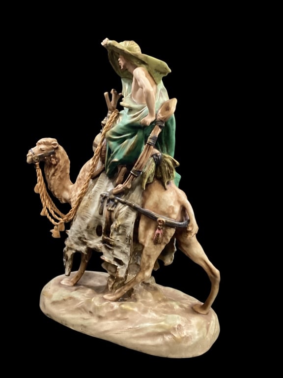 Turn Teplitz Amphora Porcelain Figural: Large Porcelain Figural depicting an Arabian riding a camel. Muted colors to both rider and camel, detailed elements, marked as Imperial Amphora, #1618, measures 16 inches x 12 inch base* repairs to