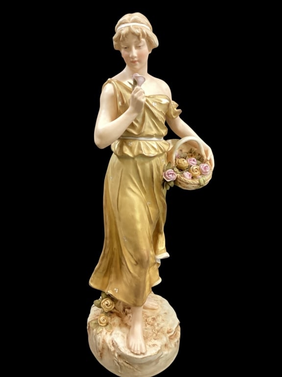 Royal Dux Porcelain Figural: Art Nouveau Figure of graceful maiden, dressed in gold draped gown, holds a badket of flowers, 20 inches tall, marked with Royal Dux pink triangle. - ()