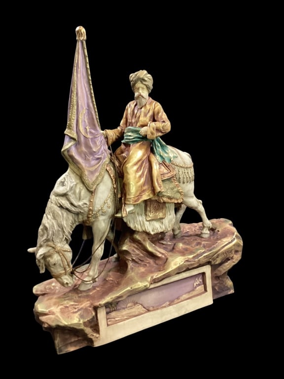 Imperial Amphora Sculpture: Impressive Large Figural sculpture of a Turk seated on his stallion. He holds a banner flag in right hand. Attribution to Imperial Amphora in Teplitz Austria, signed J. Vogt. 20 x 22 inches. - ()