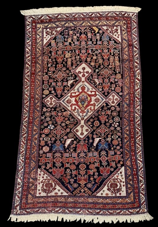 Antique Qashqai Style Rug: Early 20th century, low/flat pile, red and ivory with central cream medallion, hand woven, all over designs with winding guard borders..surface debris, age related wear, repairs, threadbare,