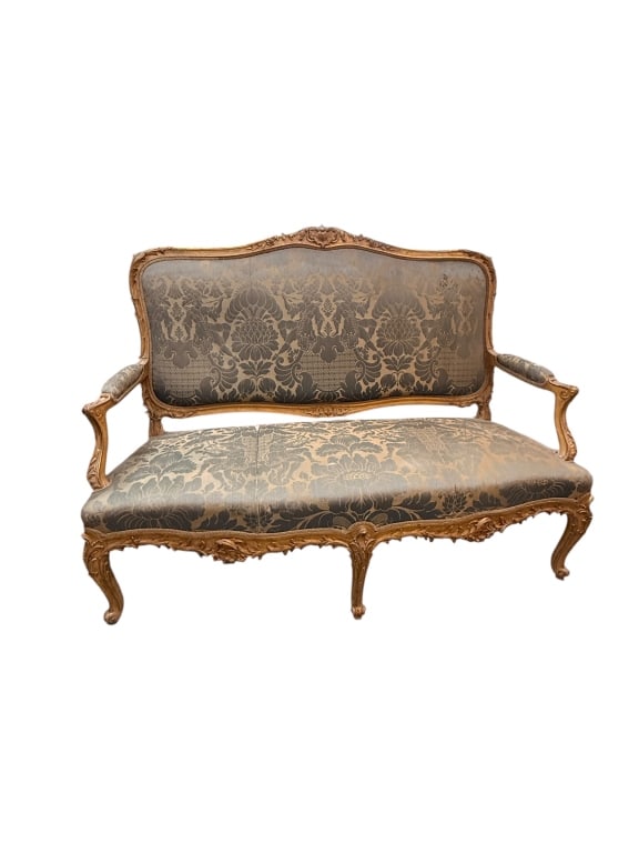 Antique French Louis XV Style Gilt Canaped Sofa: Antique French Louis XV style settee or canapé sofa featuring an ornately carved beechwood frame with a distressed gilt finish. Designed with a classic undulating serpentine camelback rail adorne