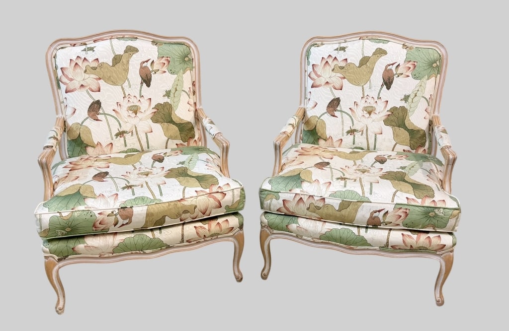 Pair of Louis XV Style Bergeres: Mid to late 20th century, white washed frames in the Louis XV style with lotus flower upholstery, overall good condition, upholstery with light surface dirt but vibrant colors, 17.5 inch seat height, 
