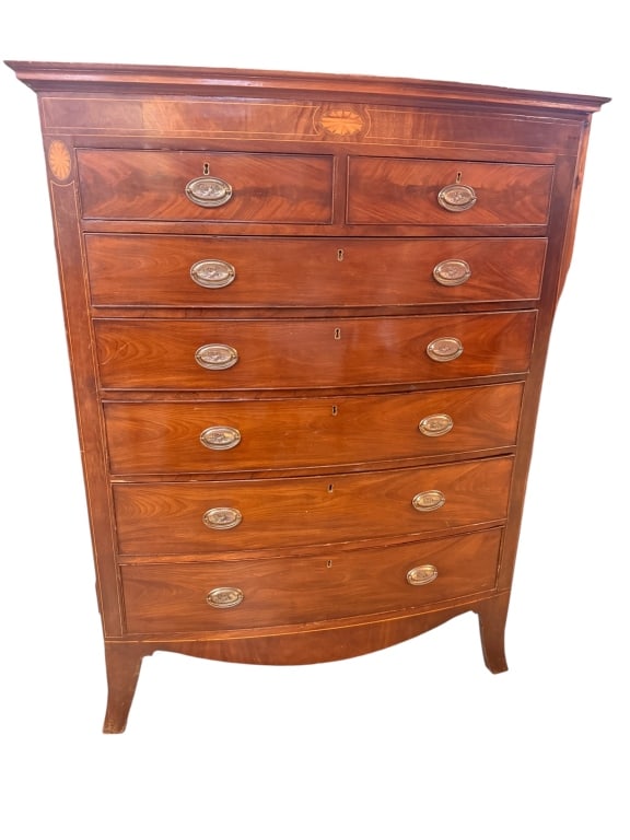 Antique 19thC Mahogany Bowfront Tall Chest: British bowfront chest of drawers crafted in rich mahogany. The top frieze features elegant satinwood stringing and a central oval patera sunburst and string inlay, with matching fan inlays capping