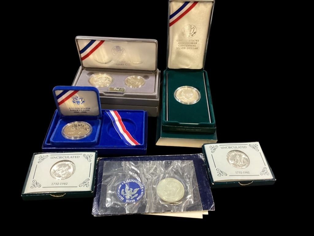 Uncirculated Silver Coins: 6 pieces- Mount Rushmore 2 Coin anniversary set, 1991, Eisenhower Centennial Silver Dollar, 1971 uncirculated silver dollar, 1986 Statue of Liberty Silver Dollar, and 2- 1982 US Mint commemorative Geo