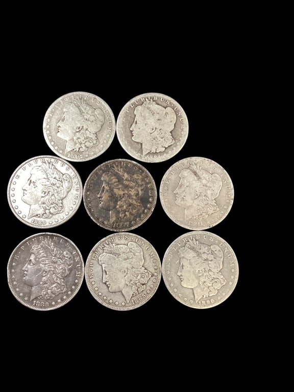Eight Morgan Silver Dollars: Circulated with wear and rubbing. Dates: 1880, 84,85, 86,89,91,97 - ()
